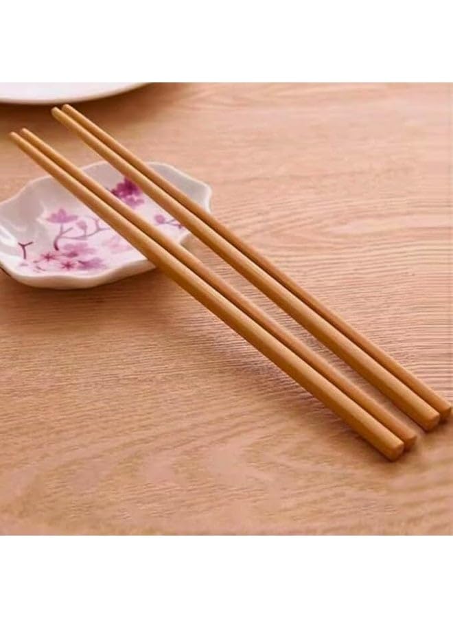 A set of 10 pairs of beautiful, reusable wooden chopsticks with a long design made of natural wood. Elegant, eco-friendly tableware, safe for everyday use in the kitchen.