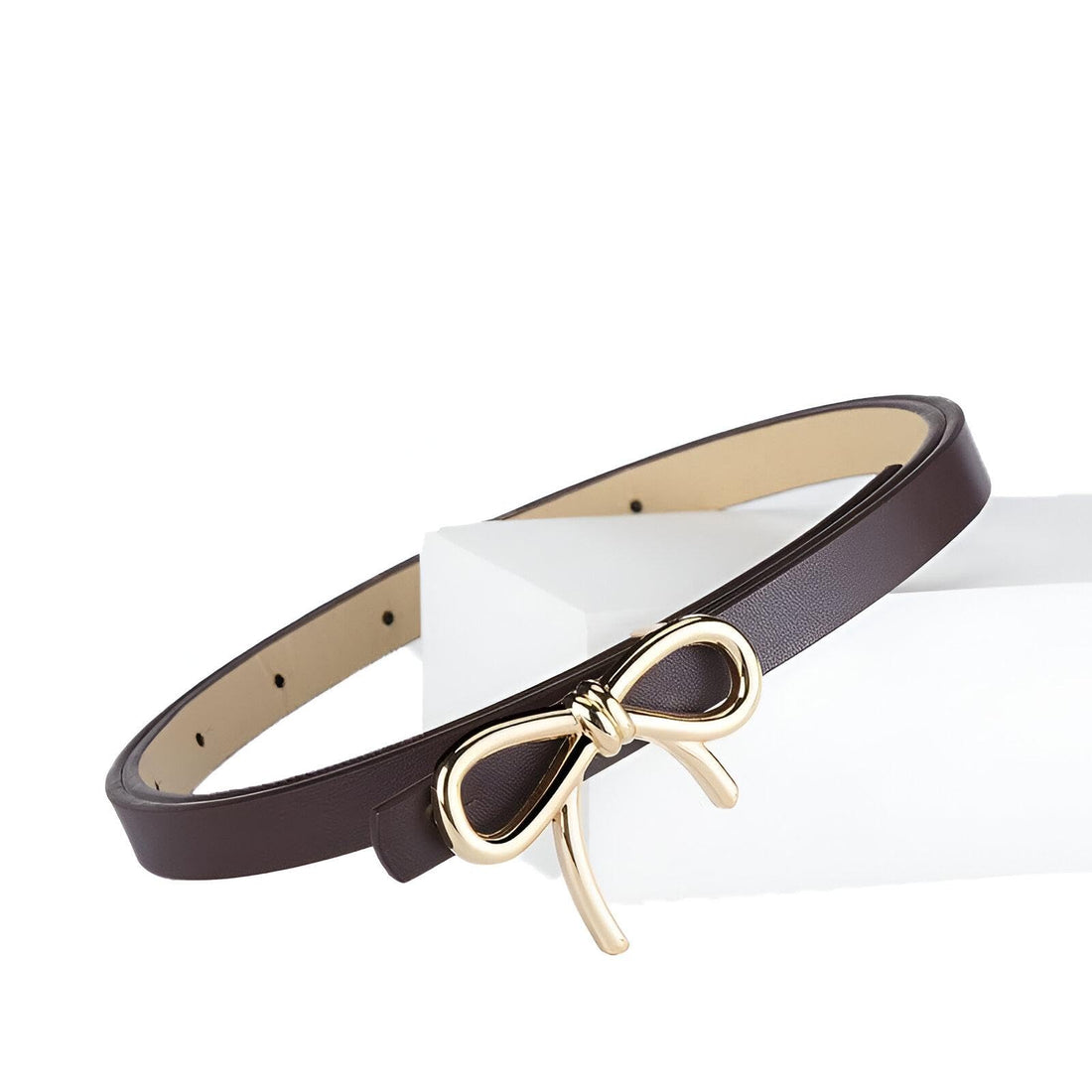 Gold Bow Belt - gold-tone belt featuring a decorative bow, slender profile ideal for dresses, jeans, and skirts, adjustable fit, smooth leather feel, perfect finishing touch for denim days.