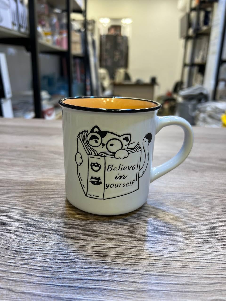 Porcelain Mug with Cat Book Design, Motivational Quote, Enamel Style with Black Rim, Interior, Ceramic. (Light Orange)
