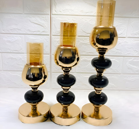 Decorative Trio - Artistic metal candle stand collection featuring black stones, crafted for luxury interior styling, enhancing festive dinners, and creating warm candlelight atmosphere